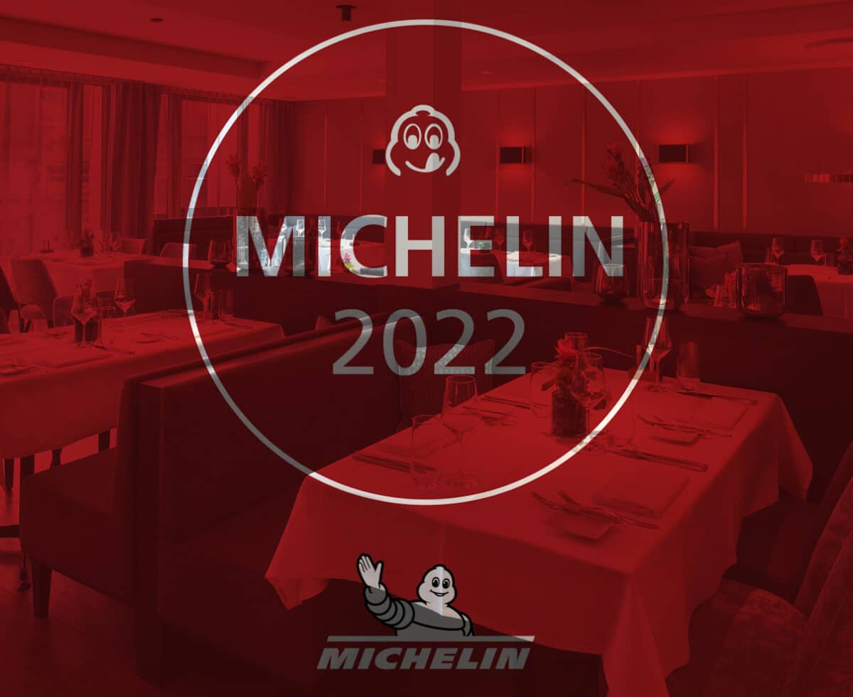 Elegantes Restaurant mit gedeckten Tischen. Text: Michelin 2022. Michelin-Männchen-Logo unten sichtbar.