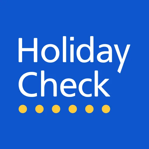 HolidayCheck-Logo auf blauem Hintergrund mit gelben Punkten unter dem Schriftzug.
